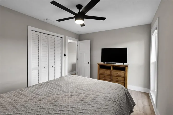 Bedroom featuring a closet, wood tiled floors, and ceiling fan