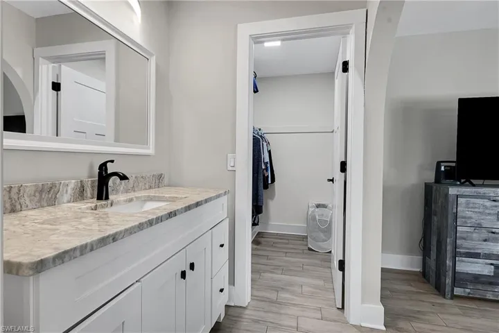 Bathroom with vanity and wood tiled floors