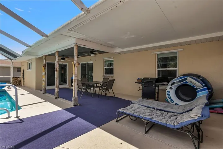 View of patio / terrace with outdoor dining area, area for grilling, an outdoor pool, a sunroom, and ceiling fan