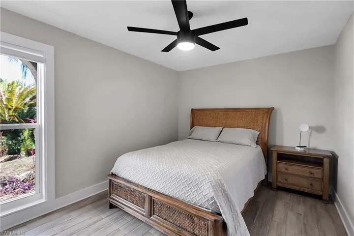 Bedroom with wood finish floors and ceiling fan