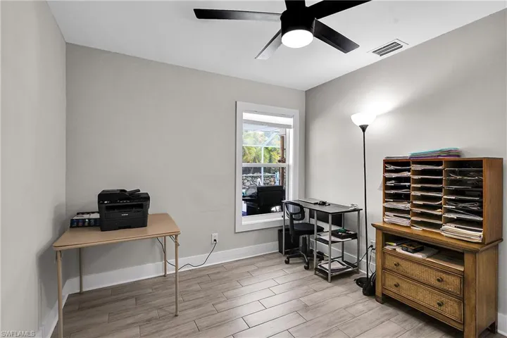 Office space with wood finish floors and ceiling fan