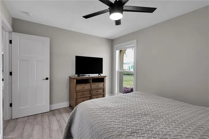Bedroom with wood finish floors and ceiling fan