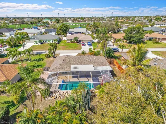 Aerial perspective of suburban area featuring a pool area