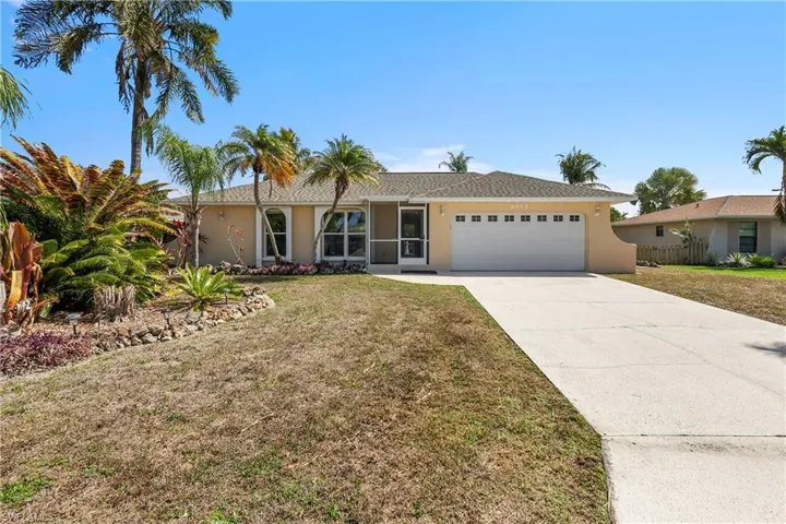Ranch-style house with stucco siding, an attached garage, and concrete driveway