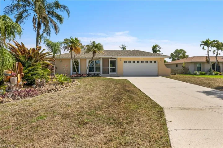 Ranch-style home featuring stucco siding, a garage, and driveway