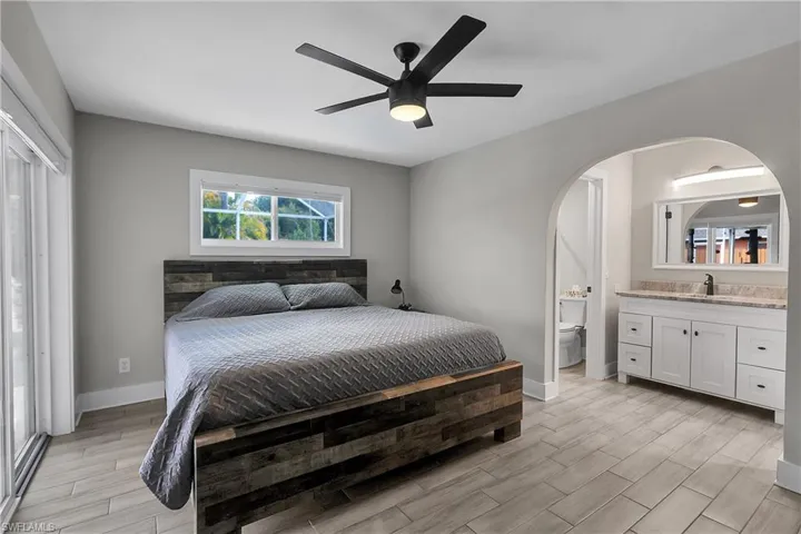 Bedroom with wood tiled floors and ceiling fan