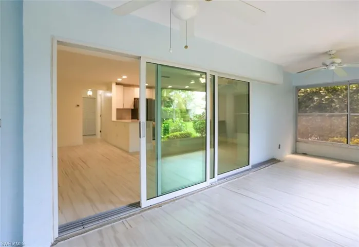 Unfurnished sunroom featuring ceiling fan and plenty of natural light