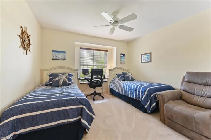 Bedroom with light carpet and ceiling fan