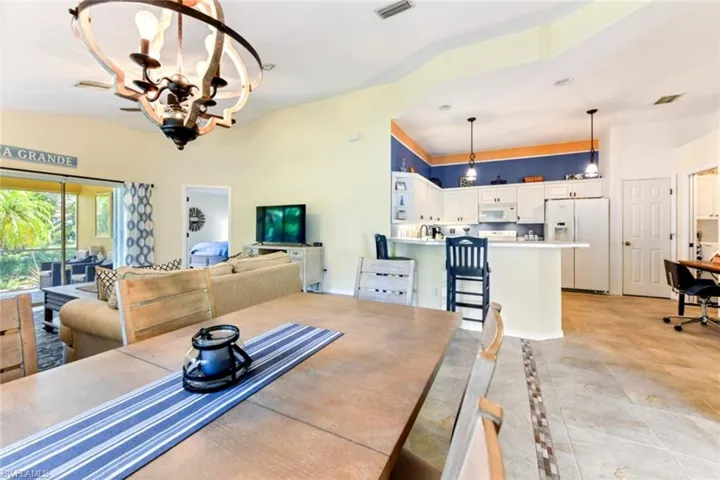Tiled dining area featuring a chandelier