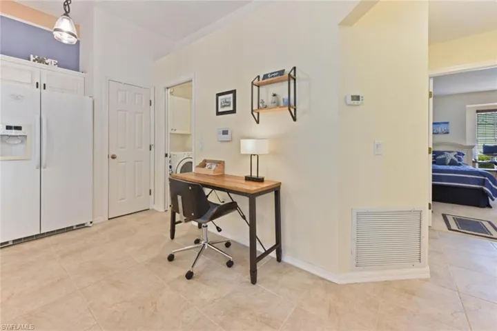 Office space featuring washer / dryer and light tile floors