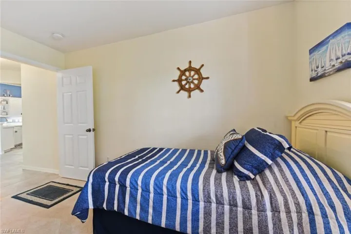 Bedroom with tile flooring and connected bathroom