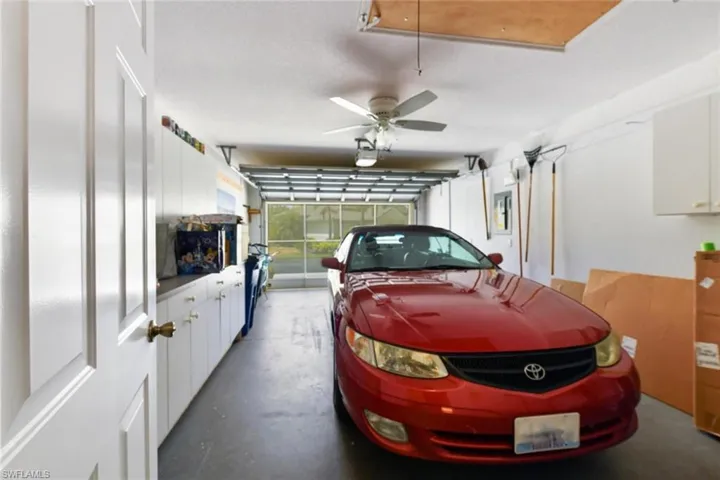 Garage with ceiling fan and a garage door opener