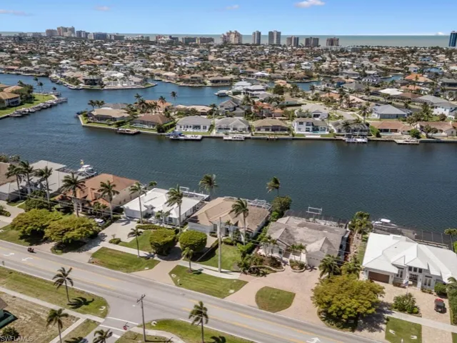 Drone / aerial view featuring a water view, a view of city, and a residential view