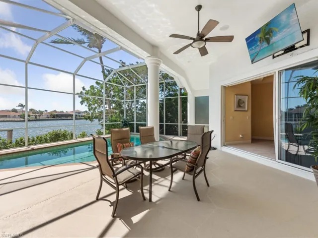 Sunroom featuring a water view, a healthy amount of sunlight, and ceiling fan
