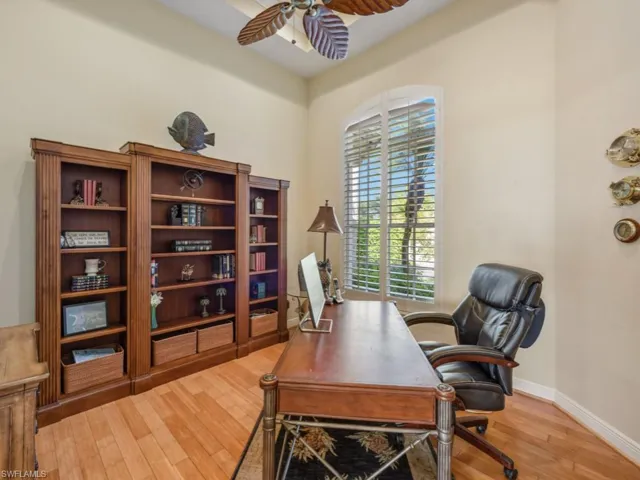 Office featuring wood finished floors, baseboards, and a ceiling fan