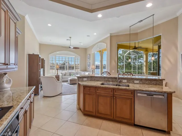 Kitchen with dishwasher, a sink, crown molding, and ceiling fan