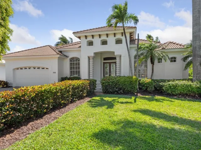 Mediterranean / spanish home featuring a tiled roof, a front yard, an attached garage, and stucco siding