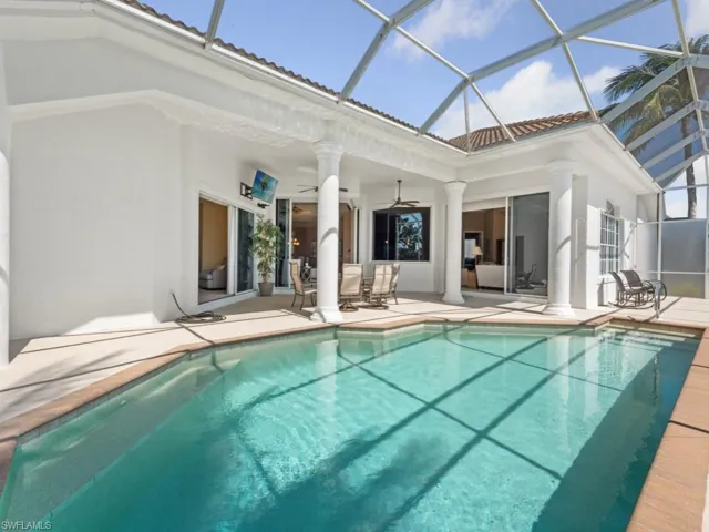 Back of house featuring a patio, stucco siding, an outdoor pool, a tile roof, and ceiling fan