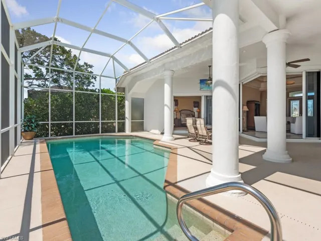 Outdoor pool with a patio, a lanai, and ceiling fan