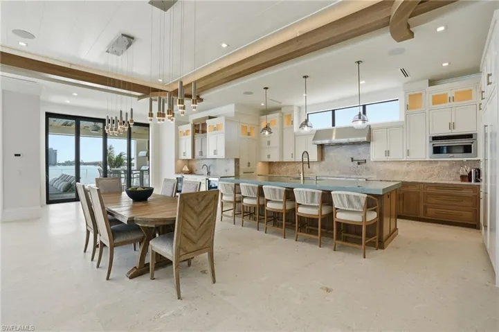 Dining room with baseboards and suspended lighting - Virtually Edited Image