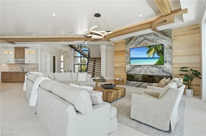 Living area with a chandelier and an accent wall - Virtually Edited Image