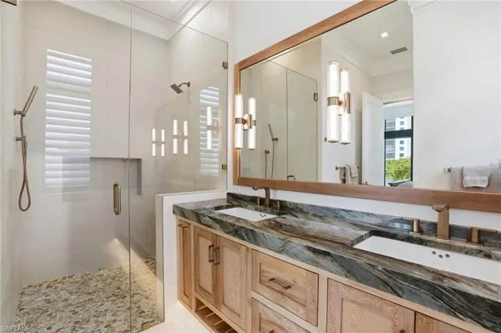 Bedroom with light wood-type flooring and crown molding - Virtually Edited Image