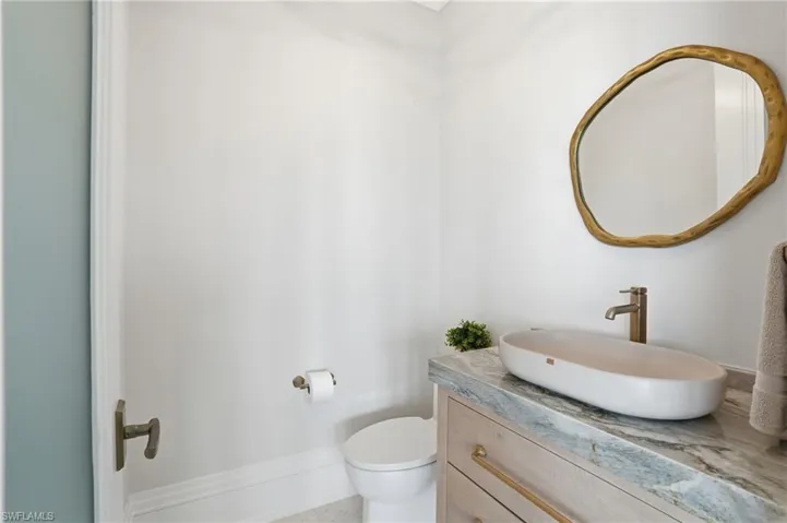 Half bathroom with toilet and vanity - Virtually Edited Image