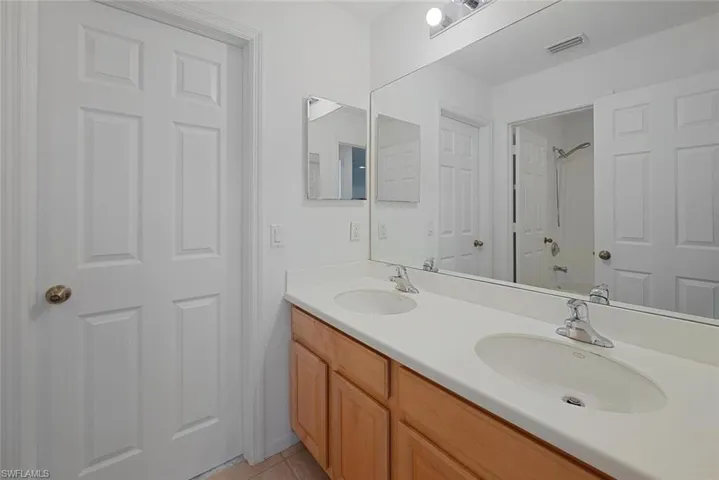 Bathroom featuring tile patterned floors and double vanity