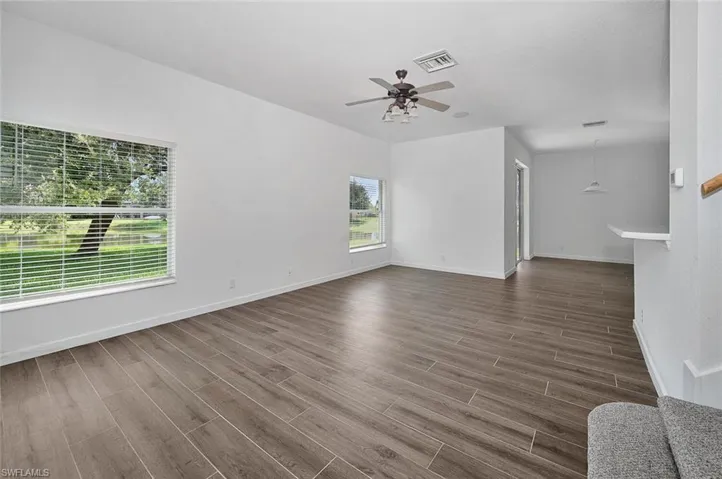 Spare room featuring dark hardwood / wood-style flooring and ceiling fan