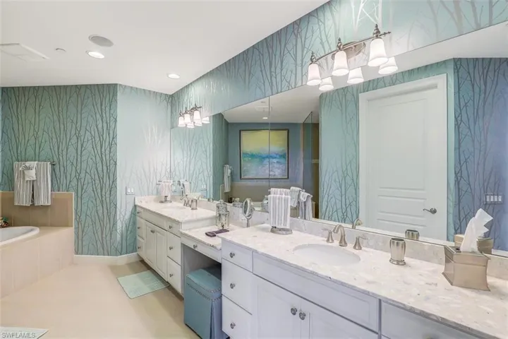 Full bath featuring wallpapered walls, vanity, a bath, and recessed lighting