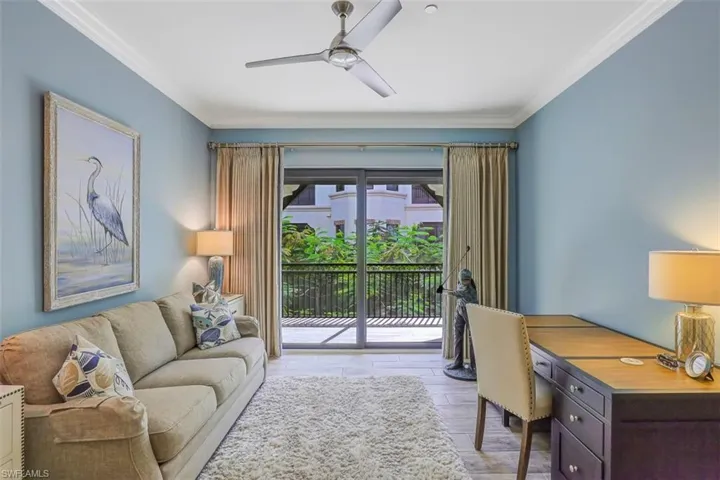 Office space featuring a ceiling fan, crown molding, and light wood finished floors