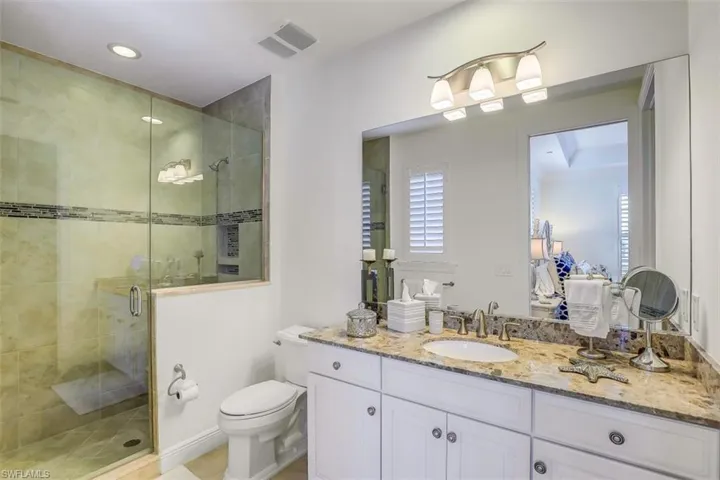 Bathroom featuring vanity, a stall shower, and recessed lighting