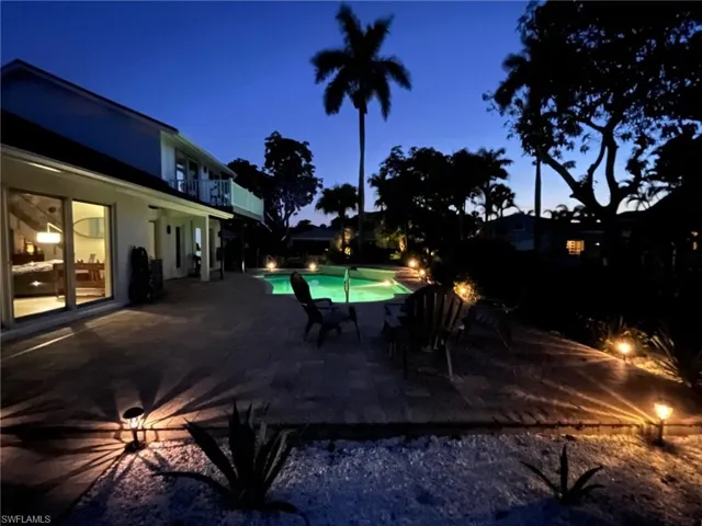 Pool at twilight with an outdoor pool and a patio