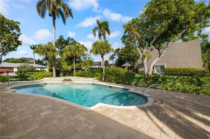 Swimming pool with an in-ground cool water spa and a patio area