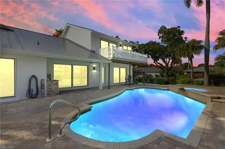 Swimming pool featuring a patio area and an in-ground cool water spa