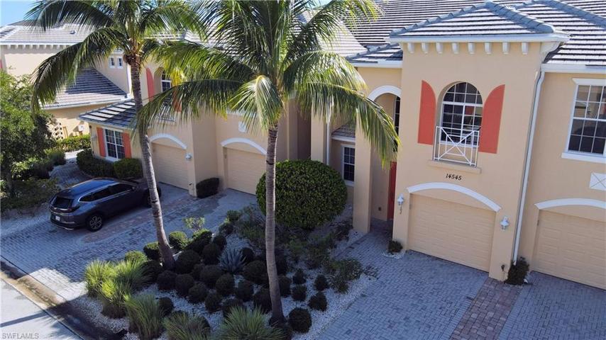 Aerial View shows front of condo building with Garages, Tropical Landscaping, Brick Paved Driveways and New Tile Roofs in 2021.