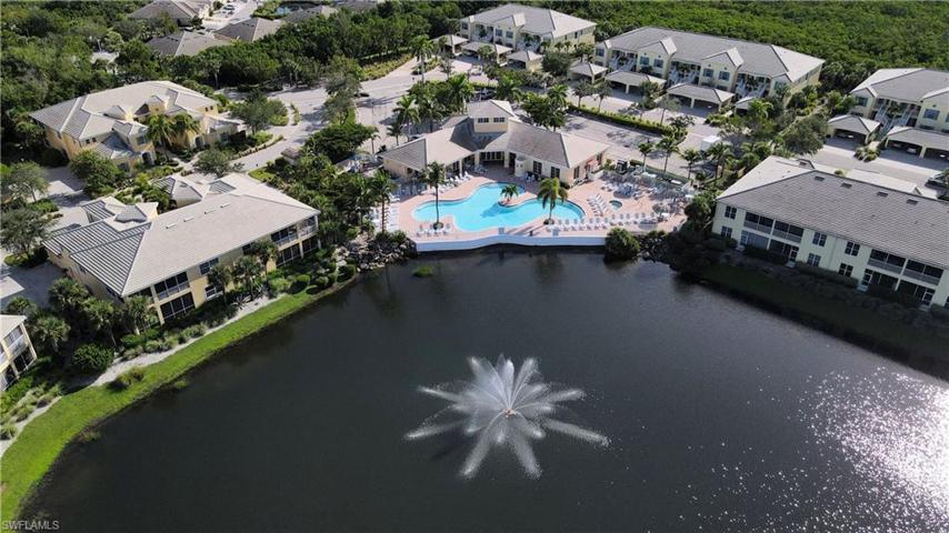 Aerial View of the Community Clubhouse Shows Resort Style Heated Pool and Spa with views of the Lake and Fountain.