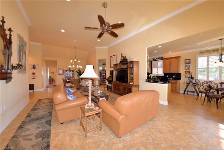 Great Room looking toward Dining room to the left and Kitchen and Breakfast area to the right. Features high Volume Ceilings, Crown Molding and 20" Diagonal Tile Flooring. Offered Turn-Key Furnished with minor exclusions of personal belongings and some art pieces.