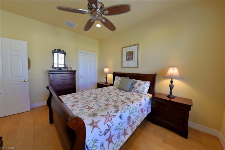 Spacious Guest Room features large walk-in closet, Custom Wood flooring & Plantation Shutters.