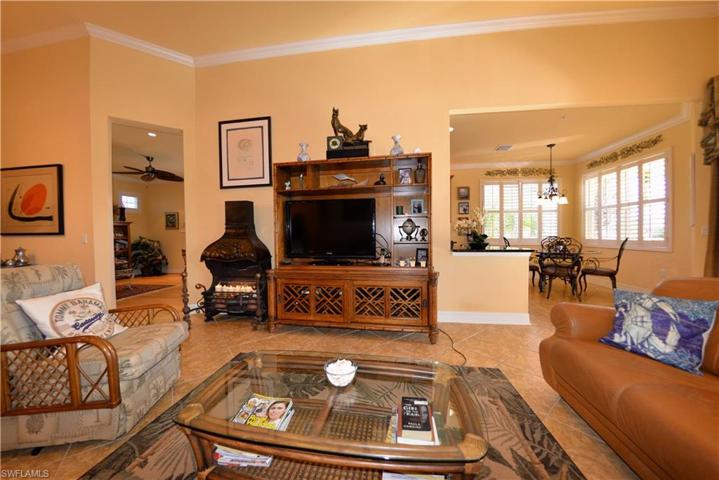 Great Room looking toward Large Den to the left and Kitchen and Breakfast area to the right. Features high Volume Ceilings, Crown Molding and 20" Diagonal Tile Flooring. Offered Turn-Key Furnished with minor exclusions of personal belongings and some art pieces.