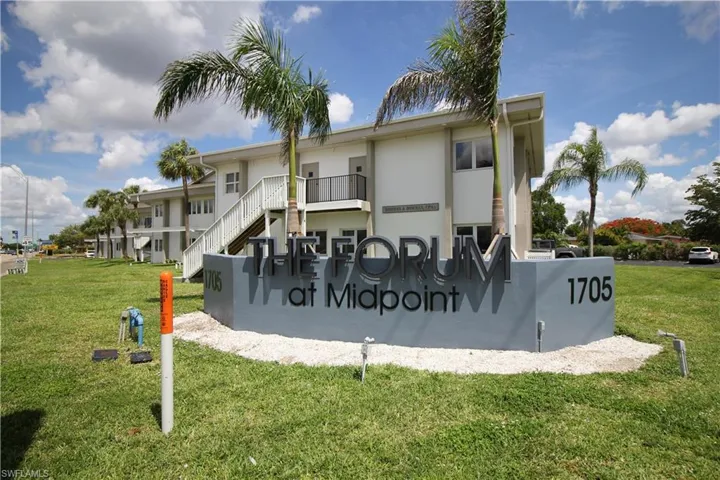 Community sign featuring a lawn
