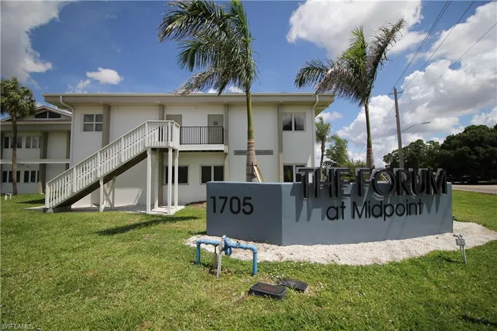 Back of property featuring a yard