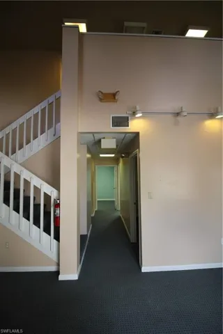 Hallway with dark carpet