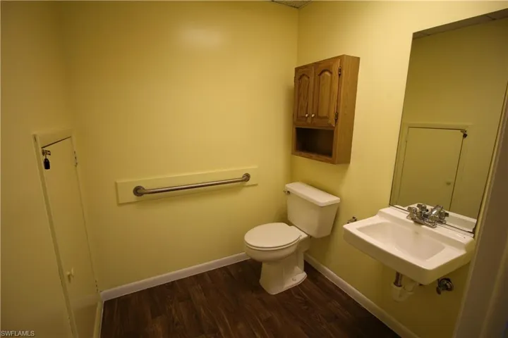 Bathroom with wood-type flooring, sink, and toilet