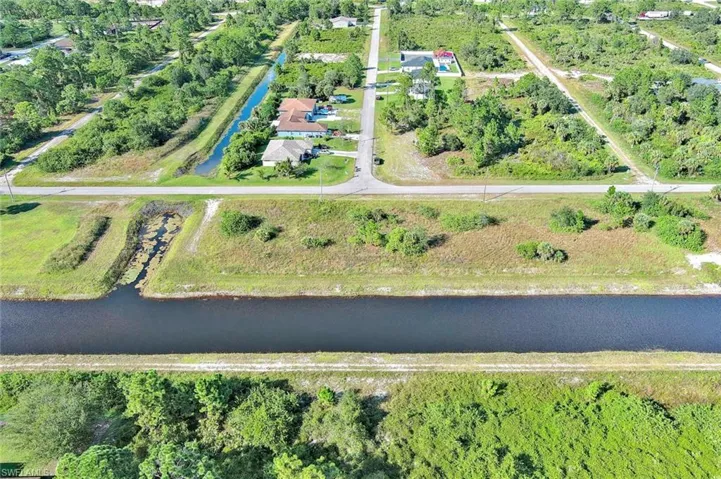 Aerial view of property's location with a large body of water