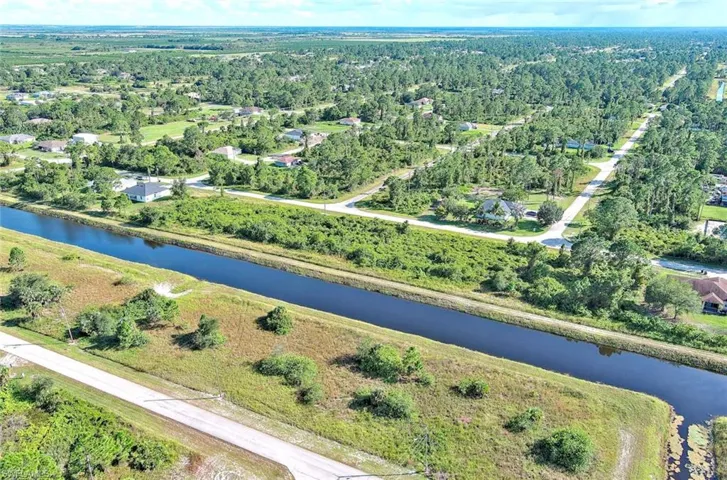 Aerial view of property's location with a large body of water