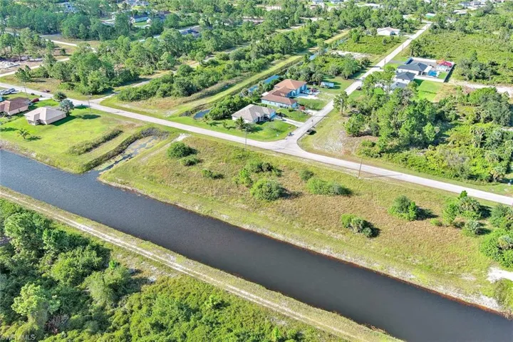 Aerial view of property and surrounding area with a large body of water