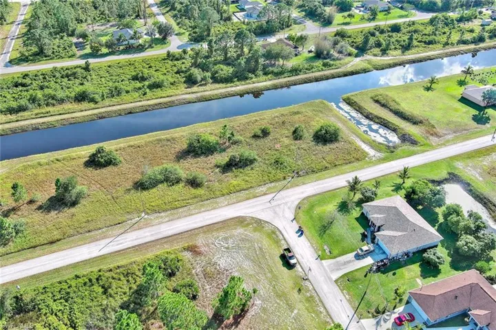 Aerial overview of property's location featuring a large body of water and a tree filled landscape