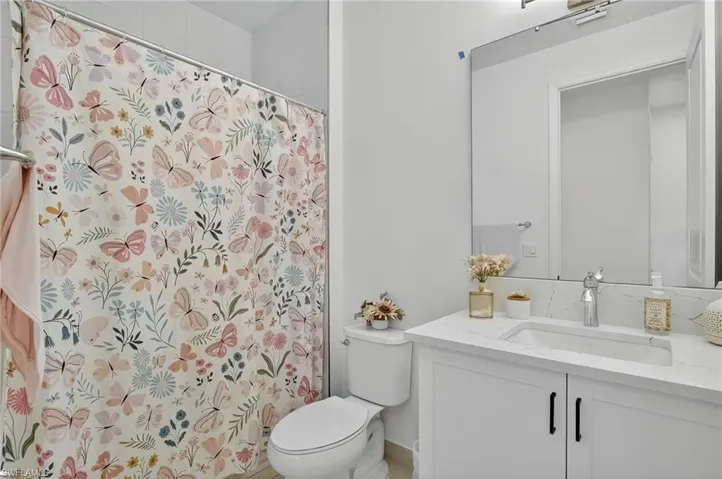 Bathroom featuring vanity and a shower with shower curtain