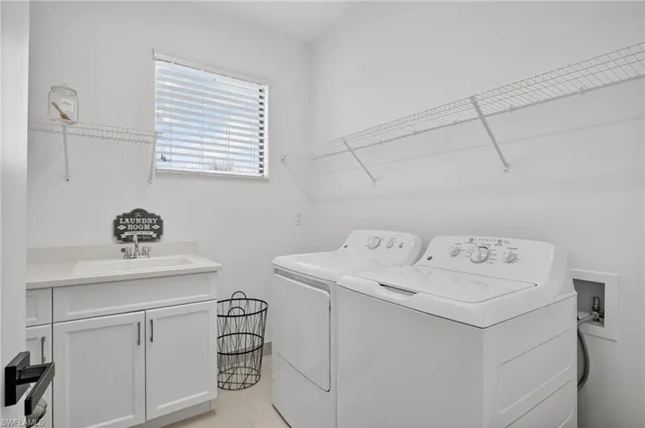 Laundry area with cabinet space and washing machine and clothes dryer